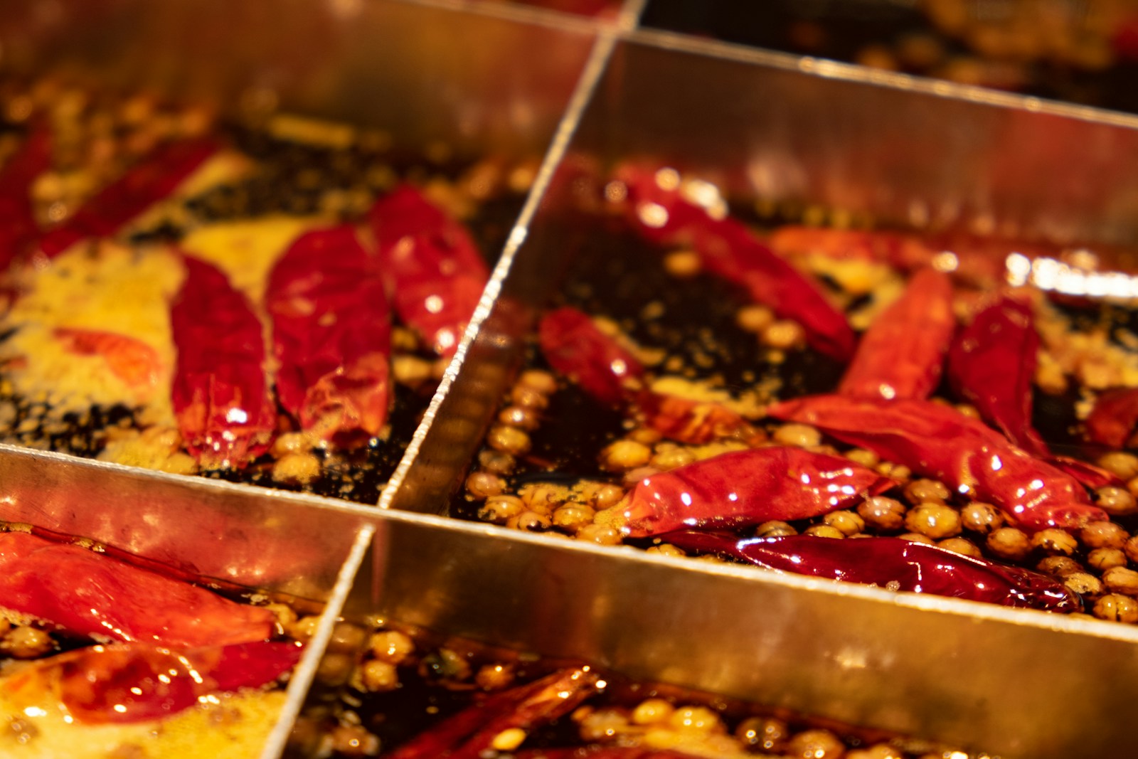 Red chillies and peppercorns in a traditional divided Chongqing hotpot
